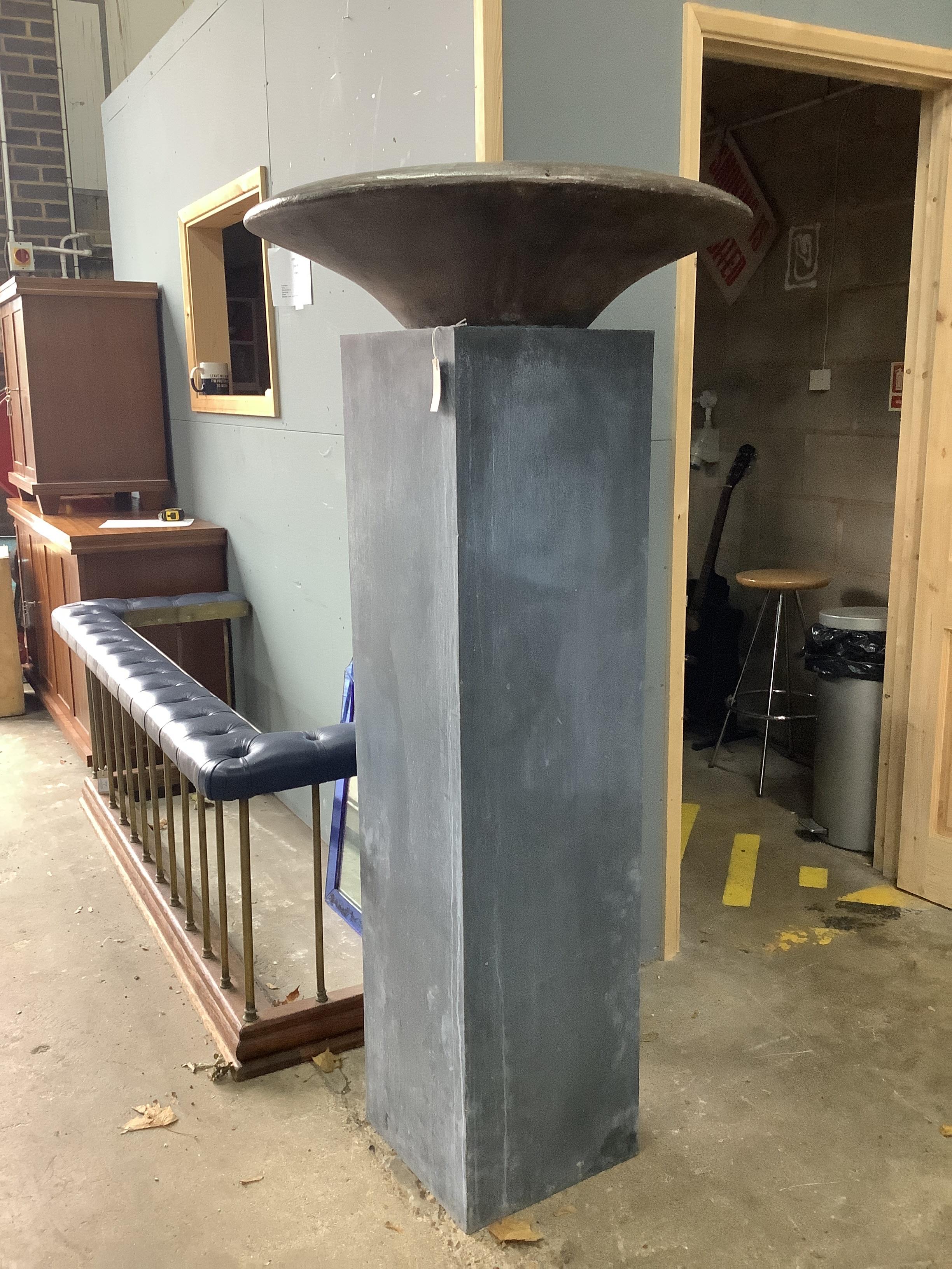 A circular bronze dish on square galvanised stand, height 160cm